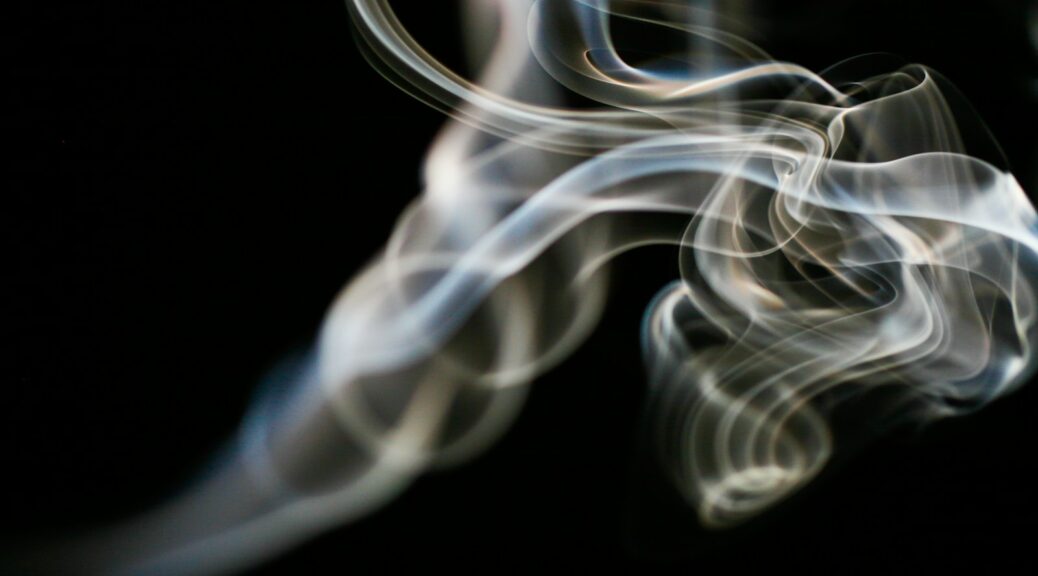 a blurry photo of smoke on a black background